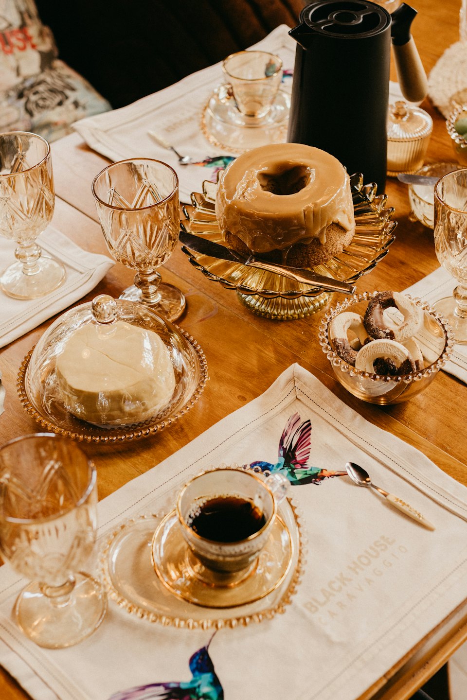 Caramel bundt cake and assorted cookies arranged on a table.